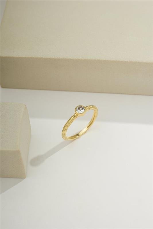 ANEL COM DETALHES ENTRELAÇADOS E ZIRCÔNIA